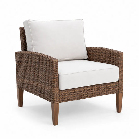 Fauteuil en résine tressée avec coussins blancs